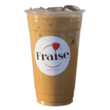 Golden Brown Cafe Latte in a Fraise Cafe with ice cubes in the drink.