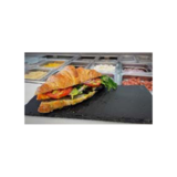 Real French Croissant sandwich with vegetables, tomatoes on slate dish.